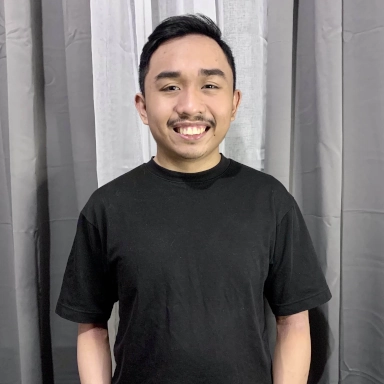 Angelo smiling with a black T-shirt